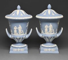 A pair of Wedgwood blue jasper ware campana vases and covers, 20th c, sprigged with An Offering to