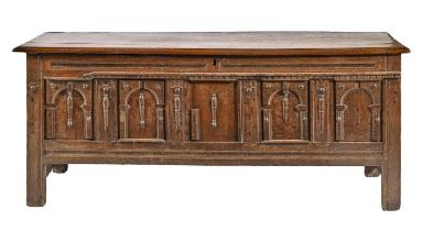 A Charles II oak chest, of panelled construction, the architectural front with arches and split