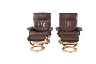 A pair of brown leather swivel and reclining armchairs and matching footstools, seat height 39cm,