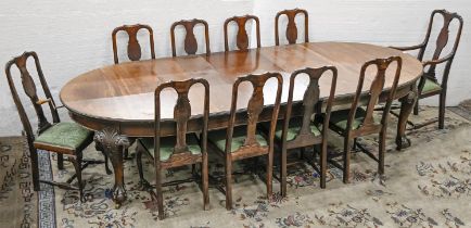 An Edwardian walnut dining table, on carved cabriole legs with claw and ball feet with brass