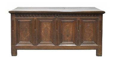 A Northern European oak chest, early 18th c, the two plank lid with ovolo lip, the four panels to