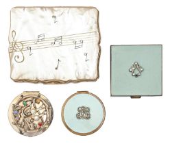 A Stratton gold plated and mother of pearl musical compact, c1960, 80mm l, two other, smaller