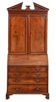 A George III mahogany bureau bookcase, with open triangular pediment and pear drop frieze, fitted