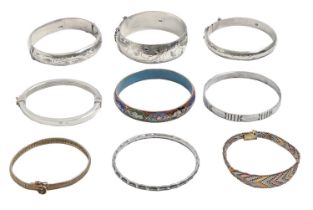 Seven silver bangles, one enamelled and two silver gilt bracelets, 5ozs 10dwts (9) Mostly good or