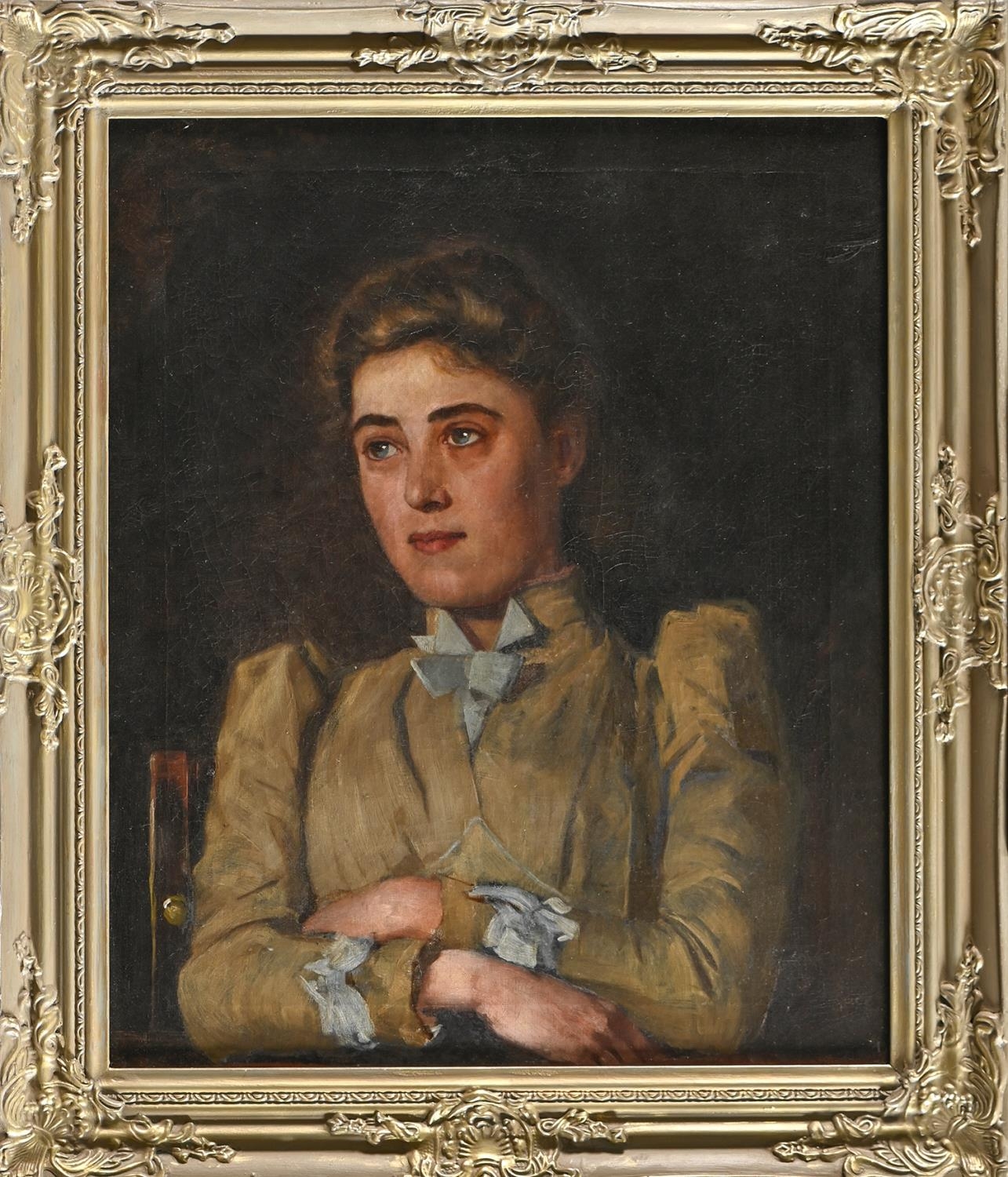 British School, early 20th c - Portrait of a Young Woman, bust length with arms folded, seated, - Image 2 of 3