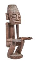 Tribal art. Oceania - a hardwood carving of a seated figure, 20th c, 56cm h Chip to top of head,