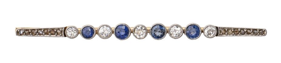 A sapphire and diamond brooch, early 20th c, millegrain and collet set in gold, 60mm l, 3.6g