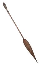 Tribal art. Oceania, a carved wood paddle or spear, mid 20th c, 177cm l and a contemporary