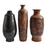 Three earthenware vases, decorated with oriental designs, 51cm h and smaller