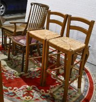 A Victorian style comb back elbow chair, a pair of rush seated kitchen stools, oak nest of tables,