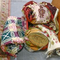 A quantity of linens and fabric, including a needlework runner, a woolwork blanket, etc