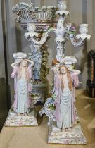 A German porcelain floral encrusted centrepiece, 52cm h, a three branch candelabra and a pair of