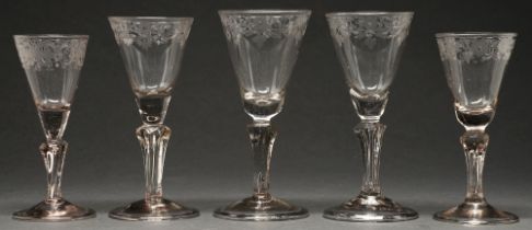 Five Bohemian wine glasses, 19th c, the rounded funnel bowl with solid base and engraved floral