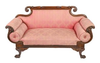 A Northern European carved mahogany settee, mid 19th c, in Empire style, 155cm l Upholstery faded,