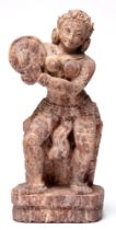 Indian sculpture. A stone statuette of a dancer or musician playing the cymbals, 32cm h Good