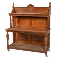 A Victorian oak buffet or 'moving sideboard', of three tiers with fluted uprights, pottery