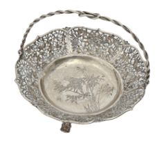 A Chinese pierced silver basket, early 20th c, with entwined handle, engraved with bird and insect