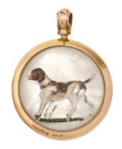 A George V 9ct gold circular pendant, with a reverse painted intaglio or Essex crystal of a gun dog,