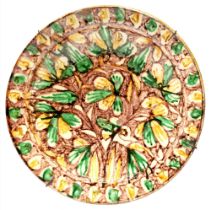 A Continental earthenware dish, 19th c, painted in green and cadmium yellow with stylised flowers on