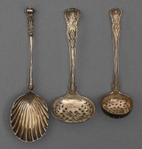Two Victorian silver sugar sifters and a serving spoon with shell bowl, London, Exeter and