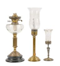 A Victorian brass oil lamp on ebonised base, with clear glass fount, 40cm h, a contemporary silvered