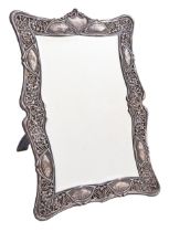 An Edward VII Art Nouveau silver dressing mirror, the openwork mount die stamped with stylised