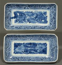 A pair of Japanese blue and white rectangular dishes, 19th c, painted with flowers in karakusa