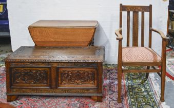 A carved and panelled oak blanket box, c1930, 47cm h; 106 x 46cm, a contemporary oak elbow chair and