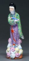 A Chinese famille rose figure of an immortal, 20th c,  in green and lavender robe, 24cm h, impressed