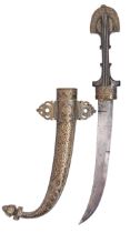 A Moroccan dagger and sheath, jambiya, c1900, with wire inlaid ebony hilt, chased brass sheath