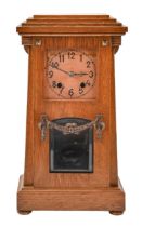 An Art Deco style German oak mantel clock, c1930, with copper dial, pendulum and key, 35cm h; 19 x