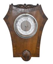 A carved and inlaid mahogany aneroid barometer, 43 x 34cm
