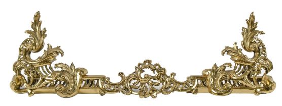 An ornate pierced brass fender, early 20th c, 95cm w