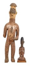 Tribal art. West Africa - an Igbo carved and stained wood figure of a standing man, 71cm h and a