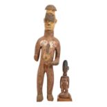 Tribal art. West Africa - an Igbo carved and stained wood figure of a standing man, 71cm h and a