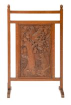 An oak firescreen incorporating a carved panel of two squirrels, mid 20th c, 48.5cm l Good