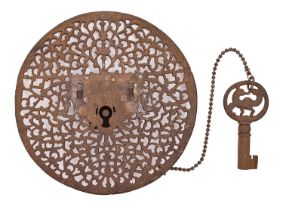 A Continental round pierced steel trunk lock and key, 18th c, the lockplate with design of strapwork