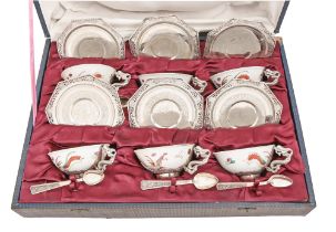 A set of six Vietnamese silver mounted dragon handled porcelain teacups, pierced octagonal saucers