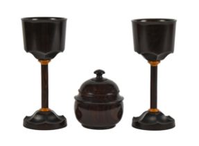 A pair of turned macassar ebony goblets, 17cm h, steel insert in base stamped R. KELL 1981 and a