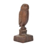 A carved wood sculpture of an owl on a stump, signed underneath the base with monogram DA dated