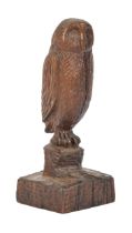 A carved wood sculpture of an owl on a stump, signed underneath the base with monogram DA dated