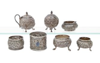 An Indian silver spherical repousse condiment set and similar salt cellar, Cutch, c1900, various