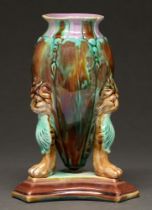 A majolica three footed vase, late 19th c, applied with lion masks, 17cm h Professional