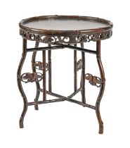 A Chinese carved hardwood bamboo-form table, early 20th c, the round top on folding frame, 69cm h;