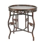 A Chinese carved hardwood bamboo-form table, early 20th c, the round top on folding frame, 69cm h;