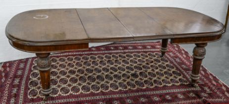 A Victorian mahogany dining table, on carved turned and fluted legs with pottery castors (two