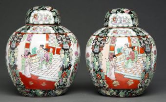 Two graduated black ground famille rose ginger jars and covers in Chinese style, 20th c, 26 and 27cm