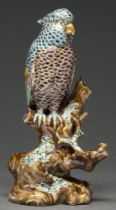 A Japanese porcelain model of a bird perched on a stump, early 20th c, 28cm h Tiny chip on edge near