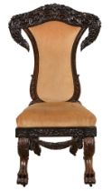 An ebony chair, prie dieu, British Ceylon, Galle District, c1850-1870, profusely carved with flowers