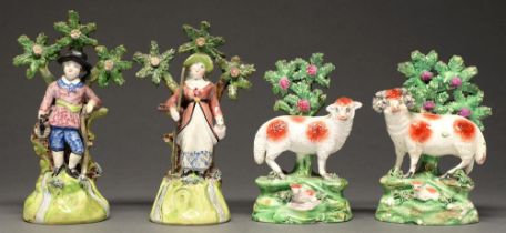 A pair of Walton earthenware figures of gleaners and a pair of Salt models of a ram and ewe, both